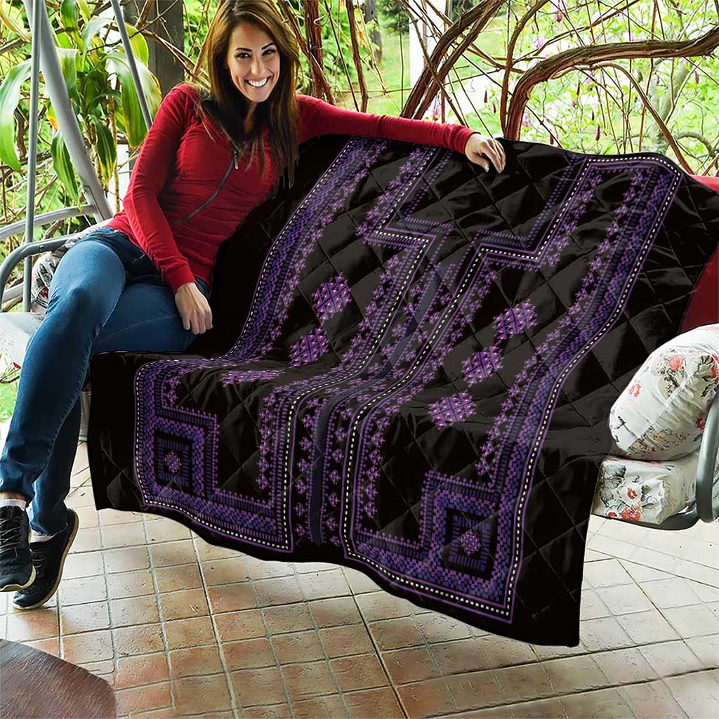 Black quilt with purple geometric striping and diamond motifs, quilted texture