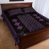 Purple geometric quilt bed set with two matching pillows on a wooden bed frame