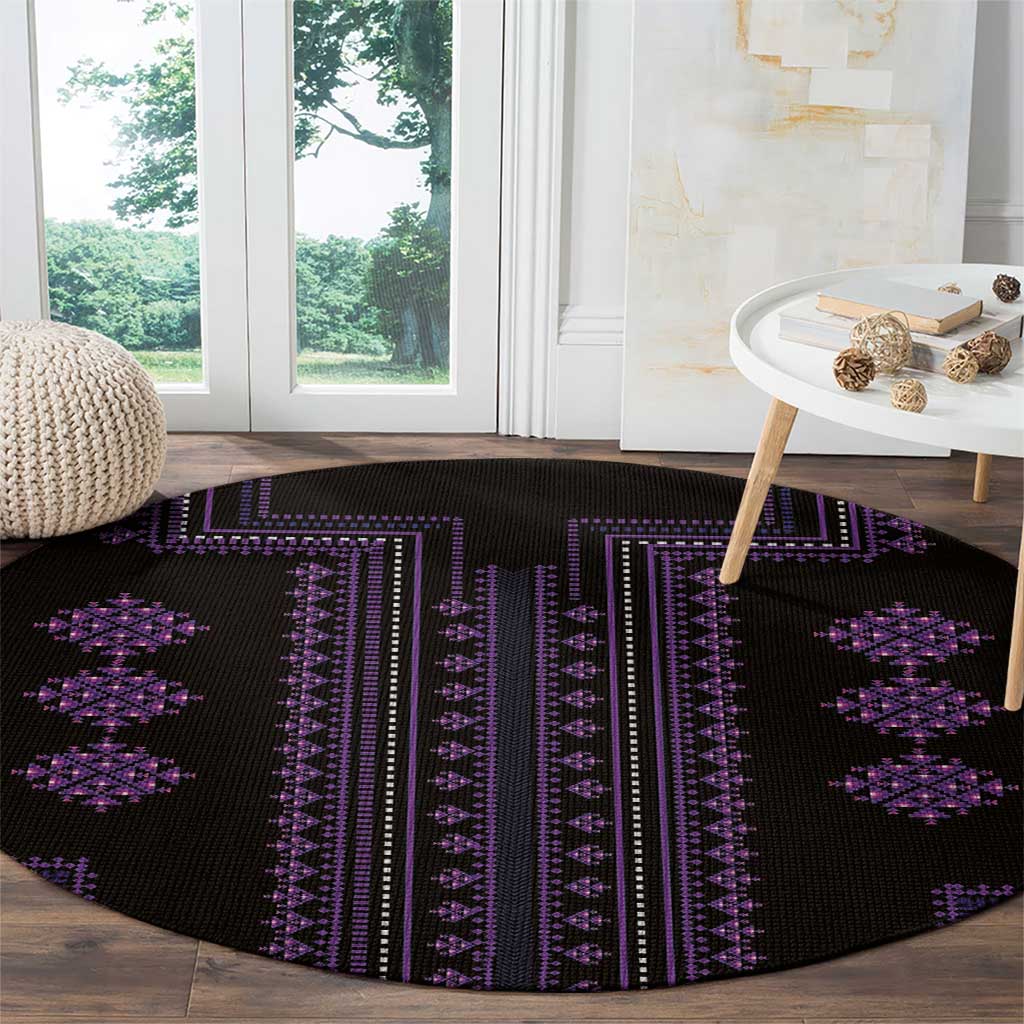Round black carpet with purple geometric stripes and diamond motifs