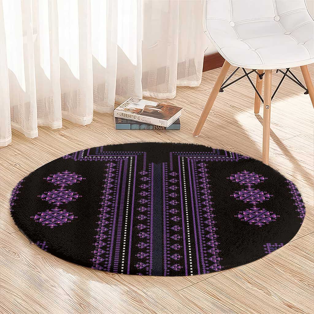 Oval-appearing round black rug with purple vertical bands and cross motifs