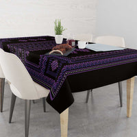 Purple and black geometric-pattern tablecloth laid on a dining table with overhang.