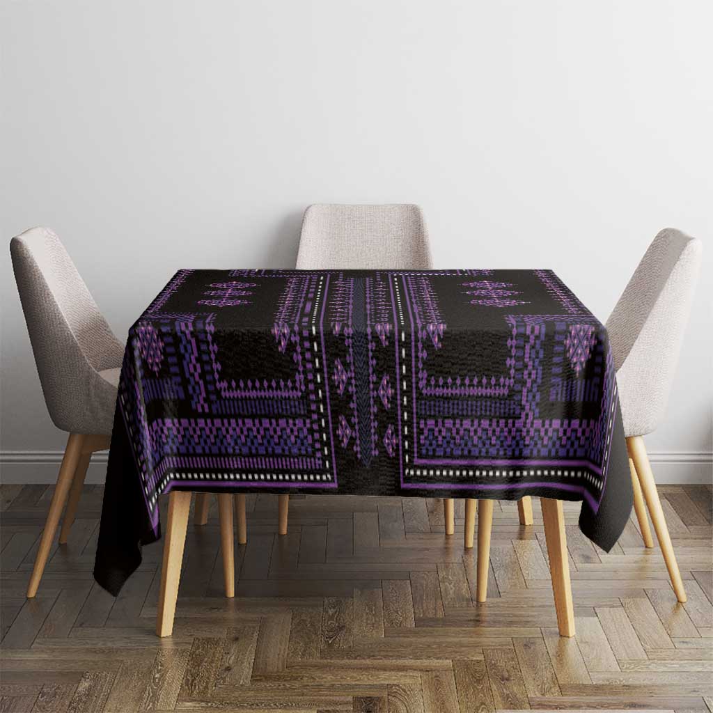 Purple and black patterned tablecloth covering a square table with chair seating visible.