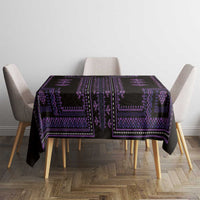 Purple and black patterned tablecloth covering a square table with chair seating visible.