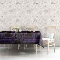 Purple and black geometric tablecloth with border design on a dining table in a room.