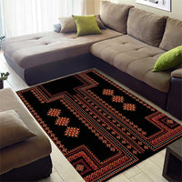 Black traditional area rug with red-orange stripes, borders, and diamond cross motifs