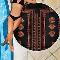 Round blanket detail with vertical red-and-orange stripes and central cross motif on black