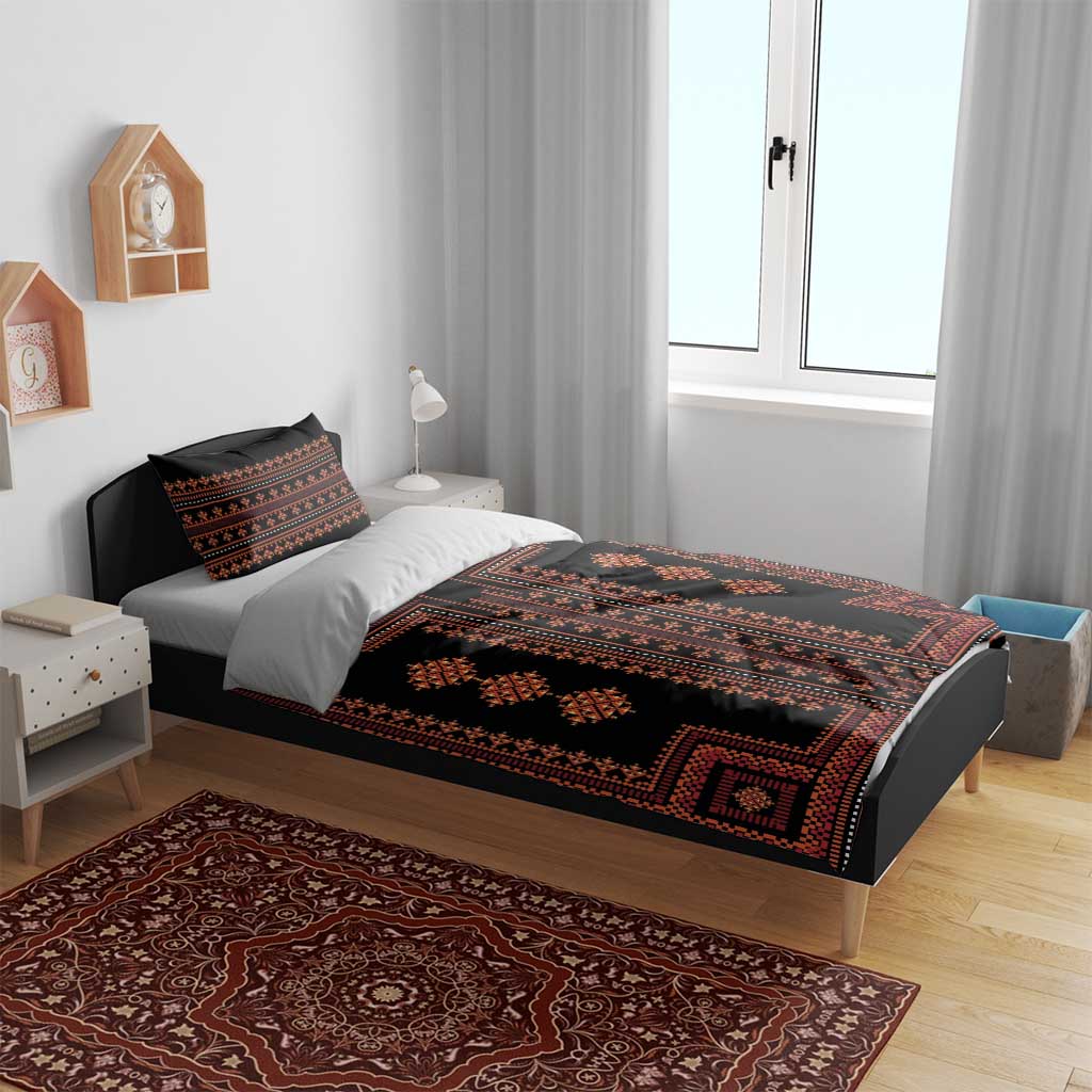 Black duvet and pillow shams with red geometric Balkan motif, laid on bed