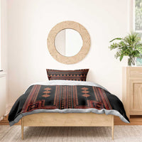 Black duvet cover with red stripe and diamond geometric pattern on bed