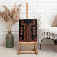 Rectangular canvas wall art on easel, black with red-orange geometric motifs