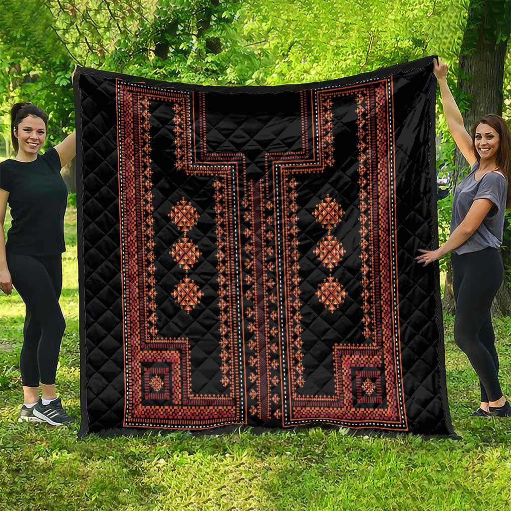 Large black quilt with red geometric stripes and diamond medallion motifs across center.