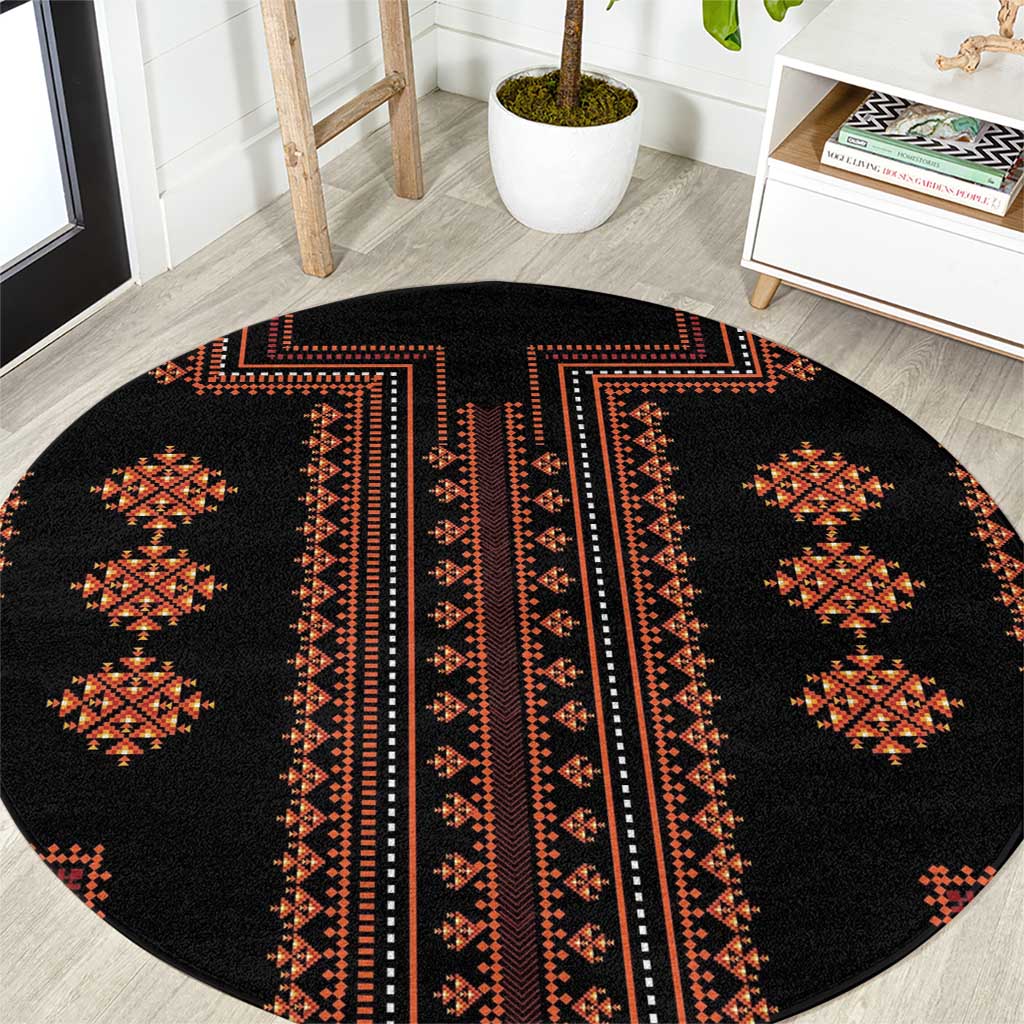 Round rug with black base and red geometric diamond patterns
