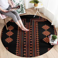 Round rug with black base and red geometric diamond stripes