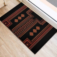 Black rubber doormat with red and orange ornamental stripes and central motifs