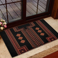 Black rubber doormat with red and orange cross motifs and patterned frame