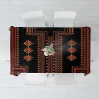Traditional tablecloth laid flat showing black fabric with red-orange panel motifs
