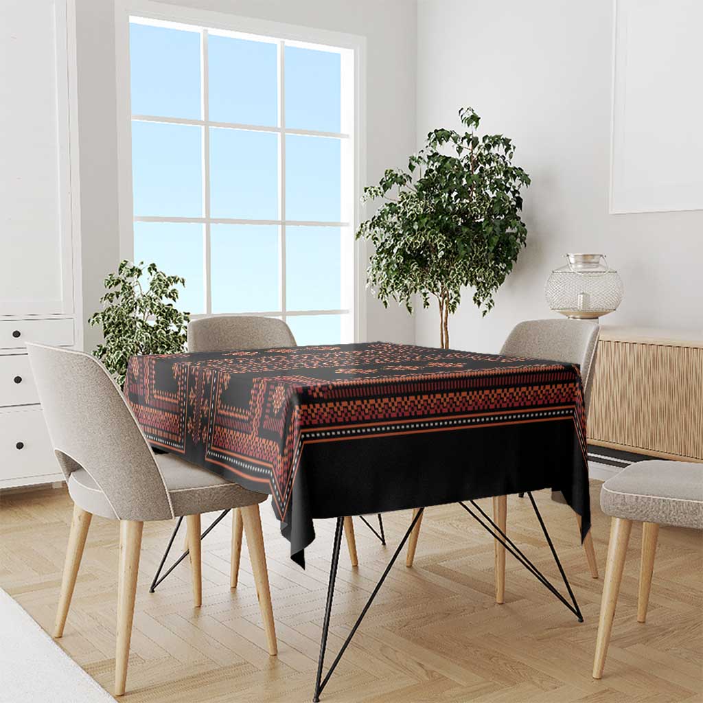 Red and black geometric patterned tablecloth draped over a dining table