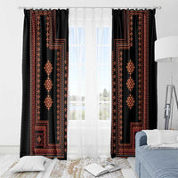 Traditional patterned window curtains with red geometric motifs on black fabric, hung on rod
