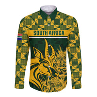 Green long-sleeve button rugby shirt with yellow geometric pattern and antelope head graphic