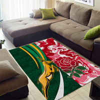 Rectangular area rug with green left and red right halves, gold animal, and white outline
