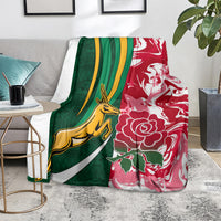 Rugby-themed throw blanket with green left side, red right side, yellow animal, and white flowers