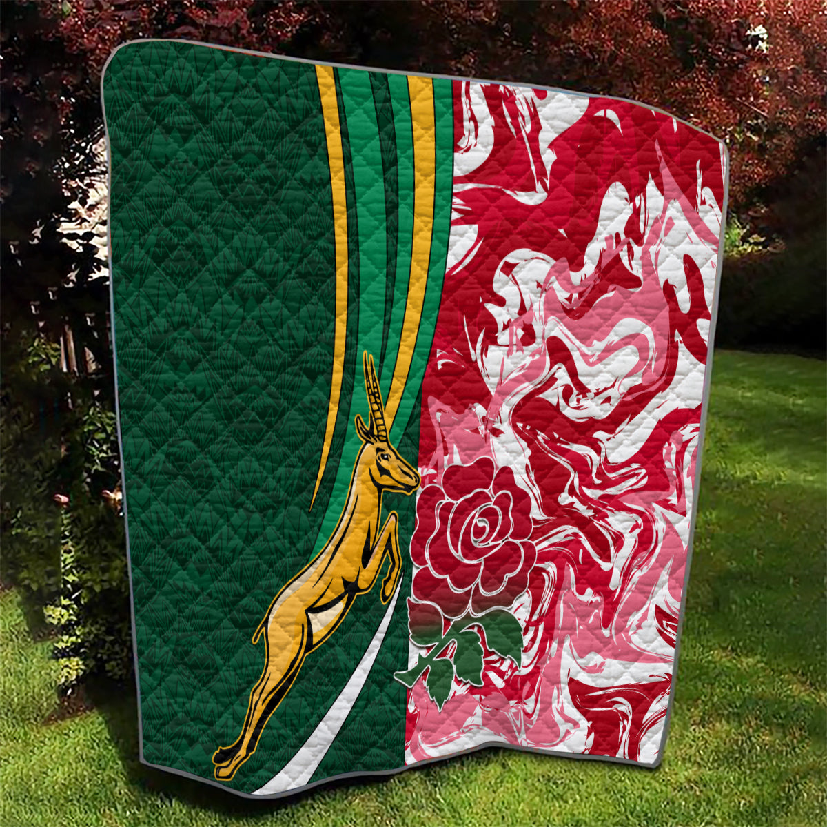Green and red quilt showing gold springbok emblem with white stripes and flower patterns