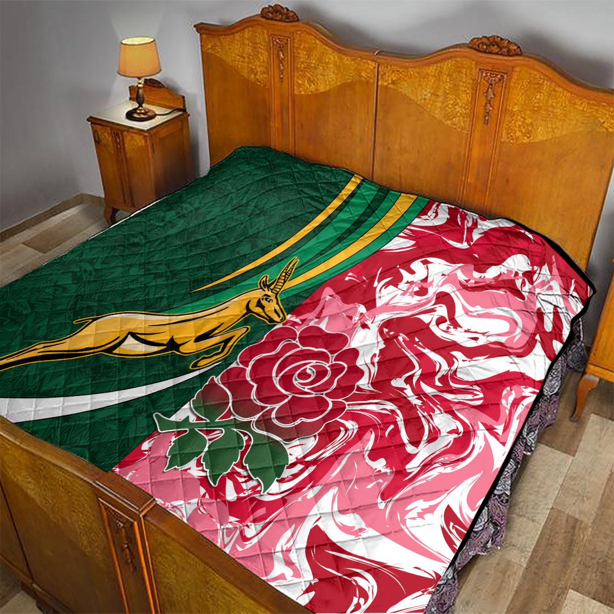 Green and red quilt on a bed with gold springbok graphic, white stripes, and flowers