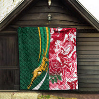 Green and red rugby quilt hanging on a wall with gold springbok and floral details