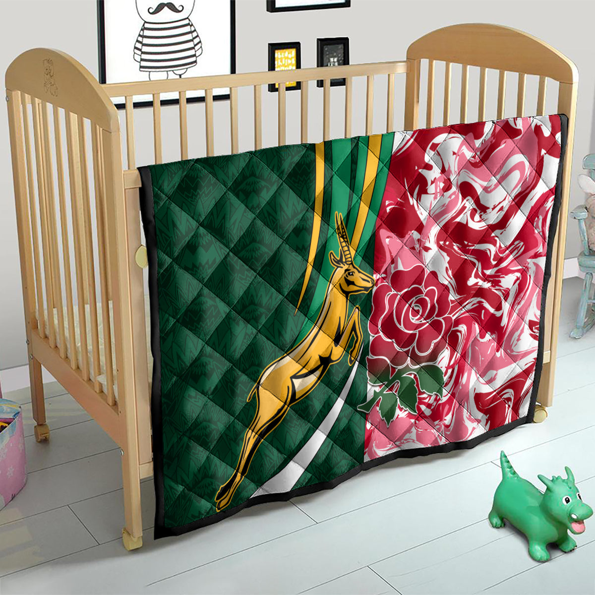 Green and red quilt on a baby bed, gold springbok emblem with floral motifs and stripes