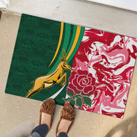 Green and red doormat with gold kangaroo and white rose swirls, rectangular shape