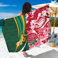 Rugby-themed sarong with red floral wave print, green panel, and yellow emblem trim