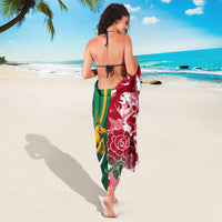 Rugby sarong in red and white floral wave print with green border and yellow figure