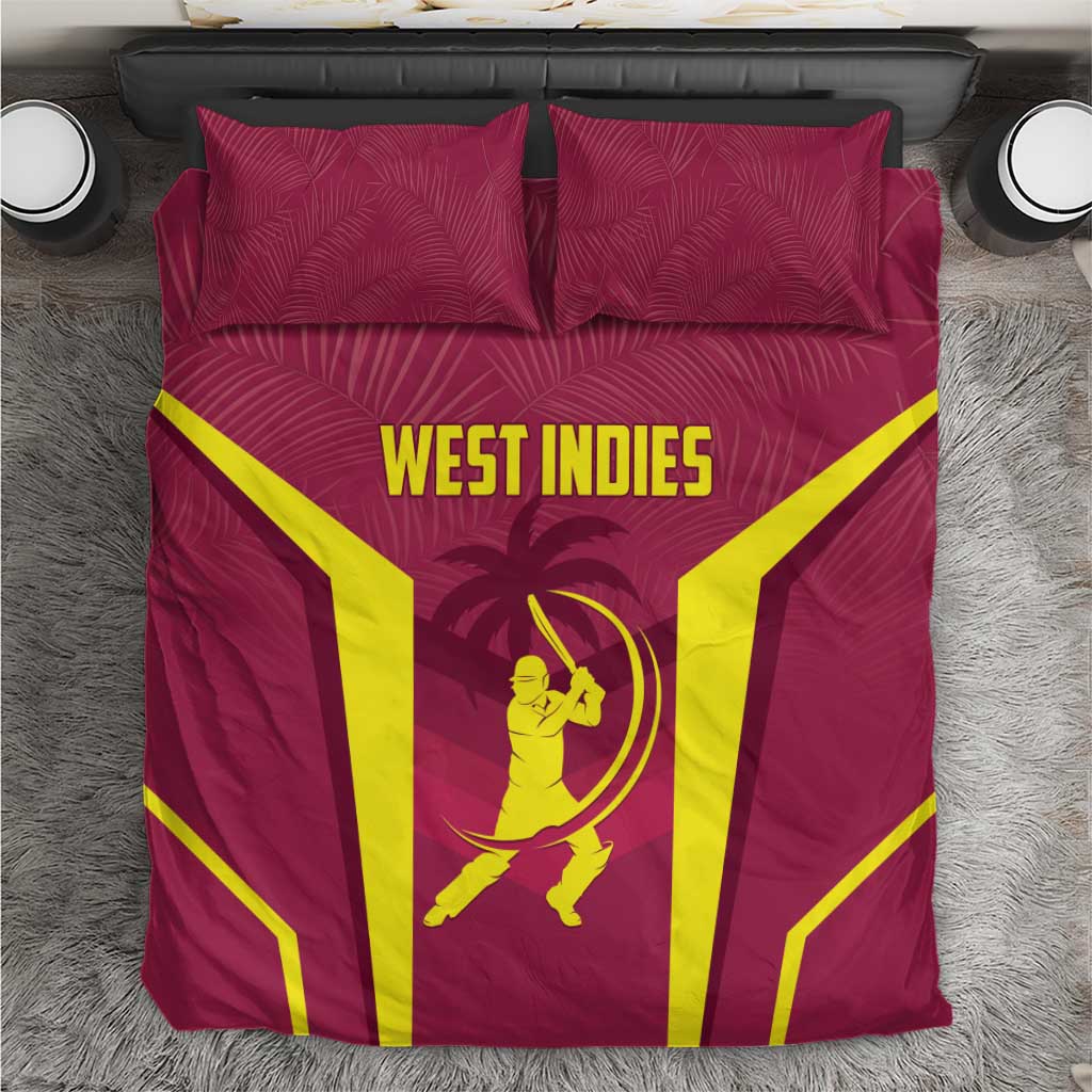 Maroon bedding set with two matching pillows and West Indies yellow logo graphic on duvet