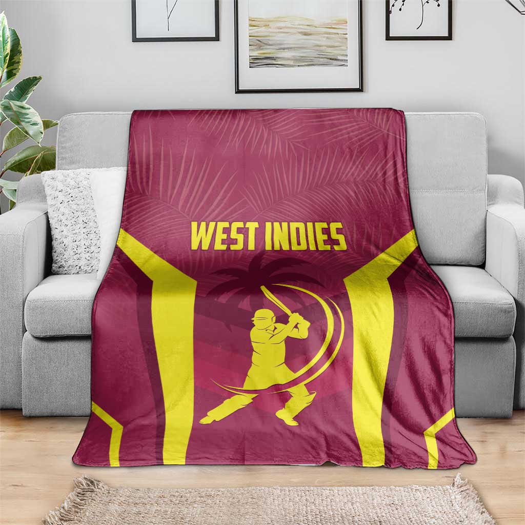 Maroon cricket throw blanket with WEST INDIES lettering and batter icon, spread on sofa