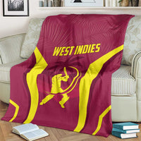Maroon cricket blanket with yellow stripes and WEST INDIES logo, draped on armchair