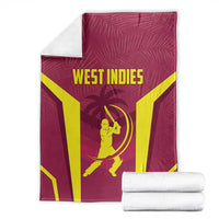 Maroon West Indies cricket blanket with yellow stripes and WEST INDIES text, folded with rolls