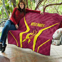 Red West Indies cricket quilt with yellow X and WEST INDIES text laid on patio seat