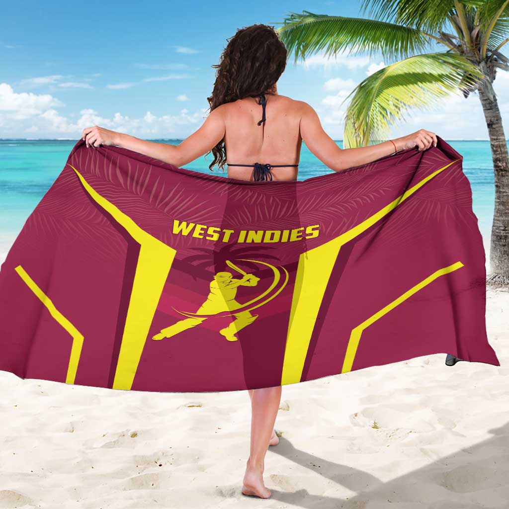 West Indies cricket sarong in maroon/red with yellow West Indies text, draped across