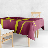 Red tablecloth with bold yellow shapes and overhanging corners on bench