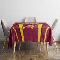 Red West Indies tablecloth with yellow vertical stripe design, laid on dining table