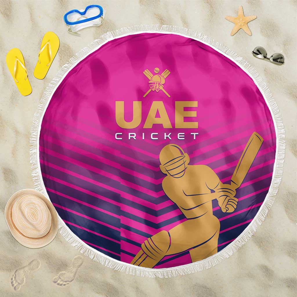 Pink round cricket beach blanket with white fringe, UAE Cricket logo and batter graphic