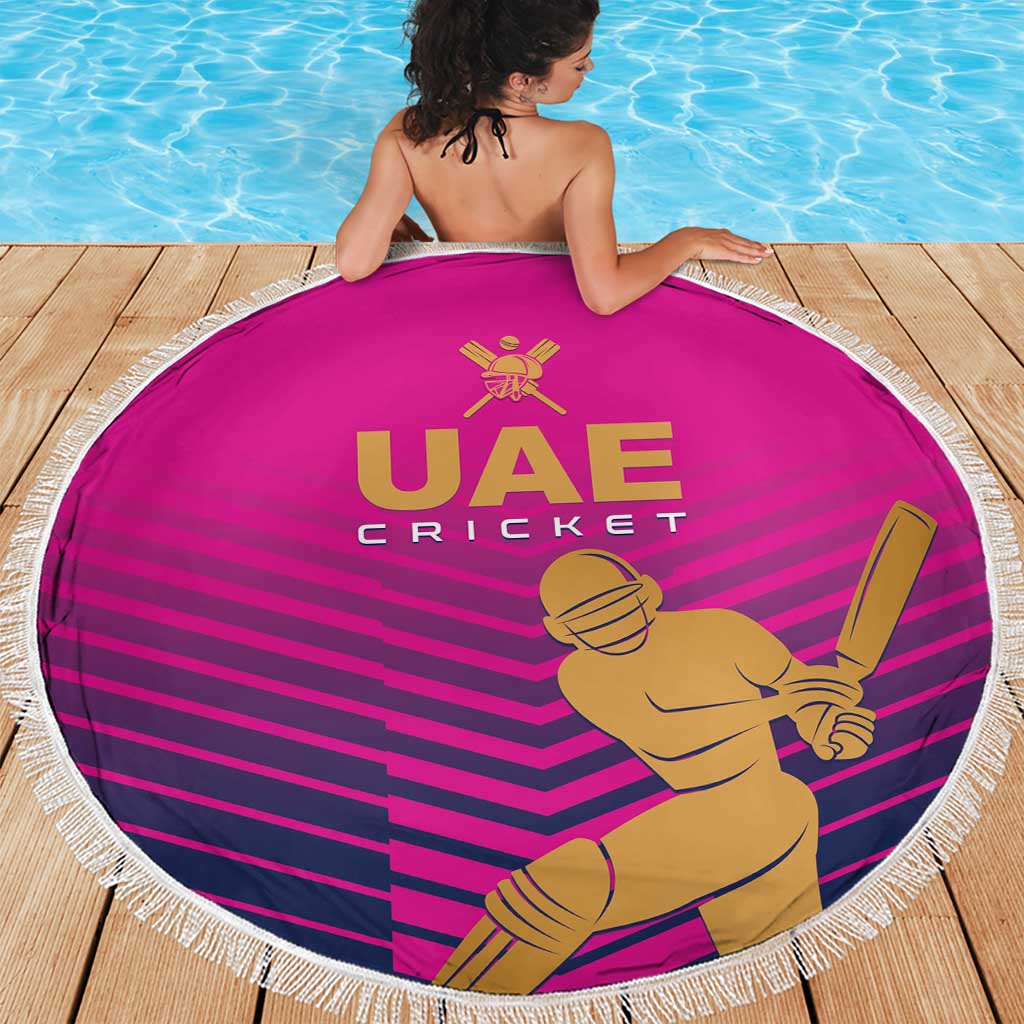 Pink circular cricket beach blanket with white tassel fringe, UAE Cricket logo and batsman