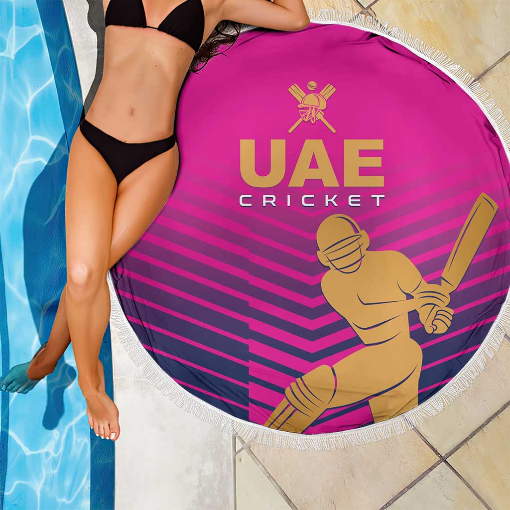Pink round cricket beach blanket with white fringe, UAE Cricket emblem and batsman artwork