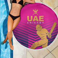Pink round cricket beach blanket with white fringe, UAE Cricket emblem and batsman artwork