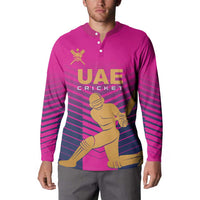 Pink boys cricket sweatshirt on model, button collar, UAE Cricket player graphic, stripes