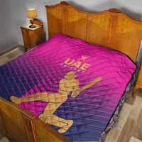 Pink UAE Cricket quilt on bed with gold “UAE CRICKET” text and bowler graphic