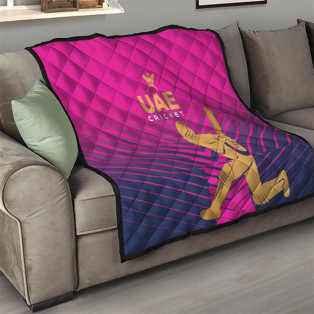 Pink UAE Cricket quilt folded on sofa with quilted diamonds and gold batsman