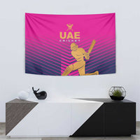 Pink UAE Cricket wall tapestry featuring gold cricket player graphic on striped design.
