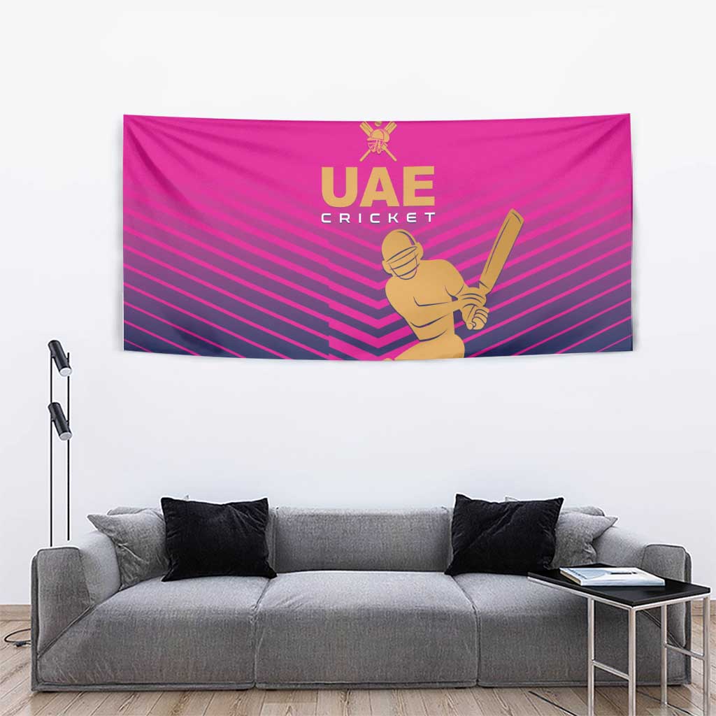 Pink UAE Cricket wall tapestry with gold batter figure and bat over dark stripes.