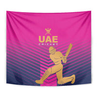 Pink UAE Cricket wall tapestry close view with gold player holding bat and logo.