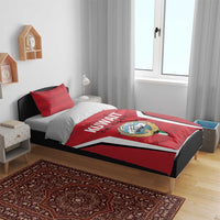Red Kuwait Cricket duvet cover and pillows on bed; crest emblem and KUWAIT CRICKET print